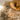 Shaggy beige ochre 70s style rug with a wooden coffee table and glasses on it.