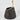 Black vase with gold rim on a white background