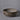 Ceramic 2 foot wide planter with textured design on a gray background