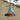 Conical silver painted outdoor pendant lamp with copper interior finish hanging against a blurred natural background