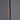 Close-up of a Stilnovo copper pendant with black cord on a gray background for Two Enlighten