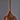 Close-up of a Stilnovo copper pendant with black cord on a gray background for Two Enlighten