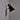 side view Black wall-mounted midcentury diabolo shaped lamp with plug and brass arm by Mauri Almari on a white background