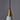 Close-up of a pendant light with a brass cone-shaped fixture against a gray background