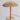 Gold table lamp with pleated shade on a light gray background