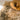 Shaggy beige ochre 70s style rug with a wooden coffee table and glasses on it.