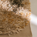 Close-up of a textured beige rug on a light background