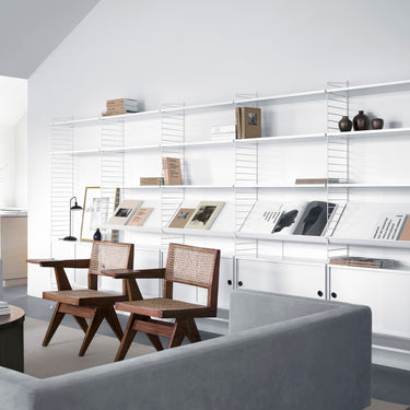 string-system-livingroom-white shelving jeanneret chairs two enlighten.jpg
