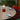 the_muse_in_pomona_red_on_table_garden_setting_close_up_lifestyle_2048x2048_f98a3f22-afa3-
