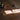 Decorative objects on a wooden surface with sunlight casting shadows