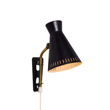 Black wall-mounted midcentury diabolo shaped lamp with plug and brass arm by Mauri Almari on a white background
