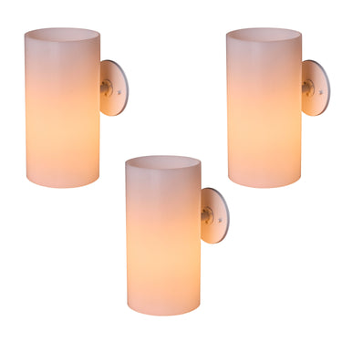 Three cylindrical wall sconces with a gradient finish on a white background powder room lighting idea