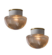 Two vintage ceiling lights with ribbed glass shades on a white background