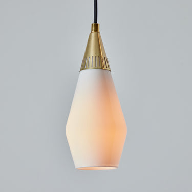 teardrop shaped midcentury Pendant light with gold fixture and white glass shade on a gray background