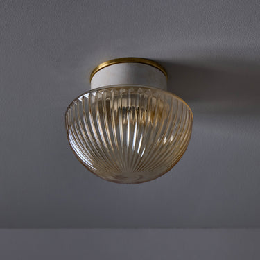 vintage Ceiling light fixture with ribbed glass shade on a gray background
