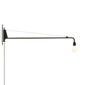 Black wall-mounted lamp with a white bulb on a white background