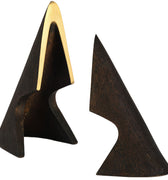 Two triangular brass bookend sulptures, one with a gold accent, on a white background
