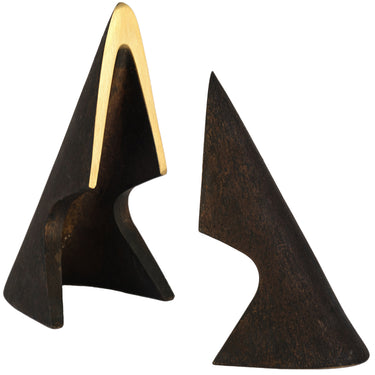 Two triangular brass bookend sulptures, one with a gold accent, on a white background