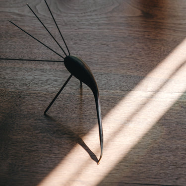 aubock bird sculpture on a wood table