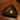 Gold star-shaped ring on a black triangular dish on a wooden surface