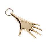 brass hand-shaped keyring on a white background