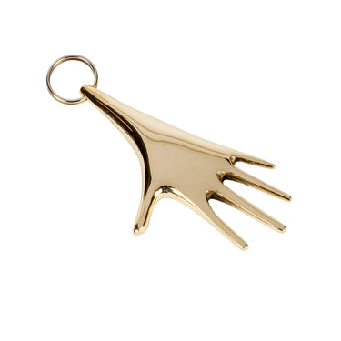 brass hand-shaped keyring on a white background