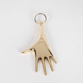 Gold hand-shaped keyring on a white background