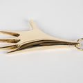 Gold hand-shaped keychain on a white background