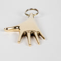 Gold hand-shaped keychain on a white background