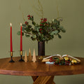 candleholder and holiday decro on a wood sfax chapo table