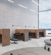 Modern office space with desks, chairs, and a large window view.
