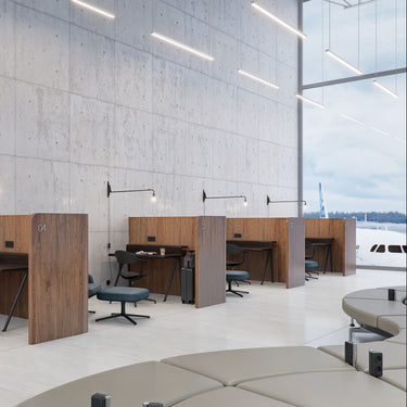 Modern office space with desks, chairs, and a large window view.