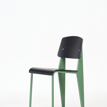 jean prouvé standard Chair with black seat and backrest and green legs on a white background