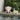 Pink elephant chair and yellow stool by a pool with greenery in the background