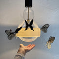 Fatterby ceiling lamp Ingo Maurer two enlighten butterflies hand.jpg