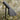 AJ Garden Modern outdoor pathway light with a black finish on a blurred natural background