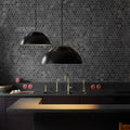 AJ royal rounded pendant kitchen with dark hexagonal tiles on the wall and black pendant lights.