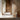 Modern outdoor setting with a wooden wall, tiled floor, and a chair with pathway lighting