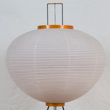 Spherical akari 10A lamp with ribbed design on a white background