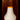 White washi paper lampshade with an orange rim and black metal stand against a wooden background