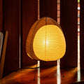 Akari lamp with a warm glow on a wooden floor