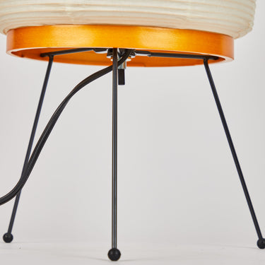 Modern table with bamboo base and black legs on a white background