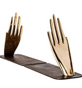 decorative hand brass aubock hands with a wooden base on a white background
