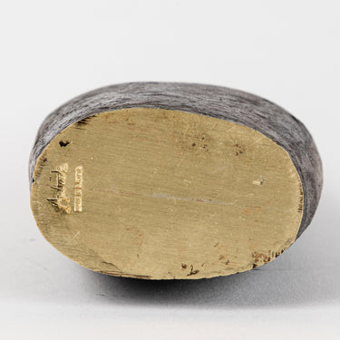 Close-up of an auboeck vase object with a textured surface on a white background