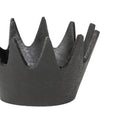 Black metal crown-shaped object on a white background