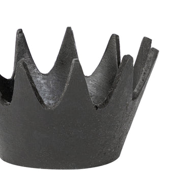Black metal crown-shaped object on a white background