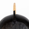 Black auböck watering canwith a cane wrapped handle on a white background