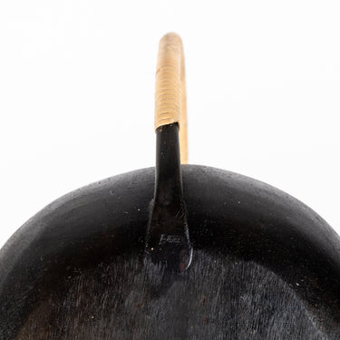 Black auböck watering canwith a cane wrapped handle on a white background