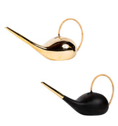 brass and black watering cans on a white background