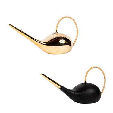 brass and black watering cans on a white background